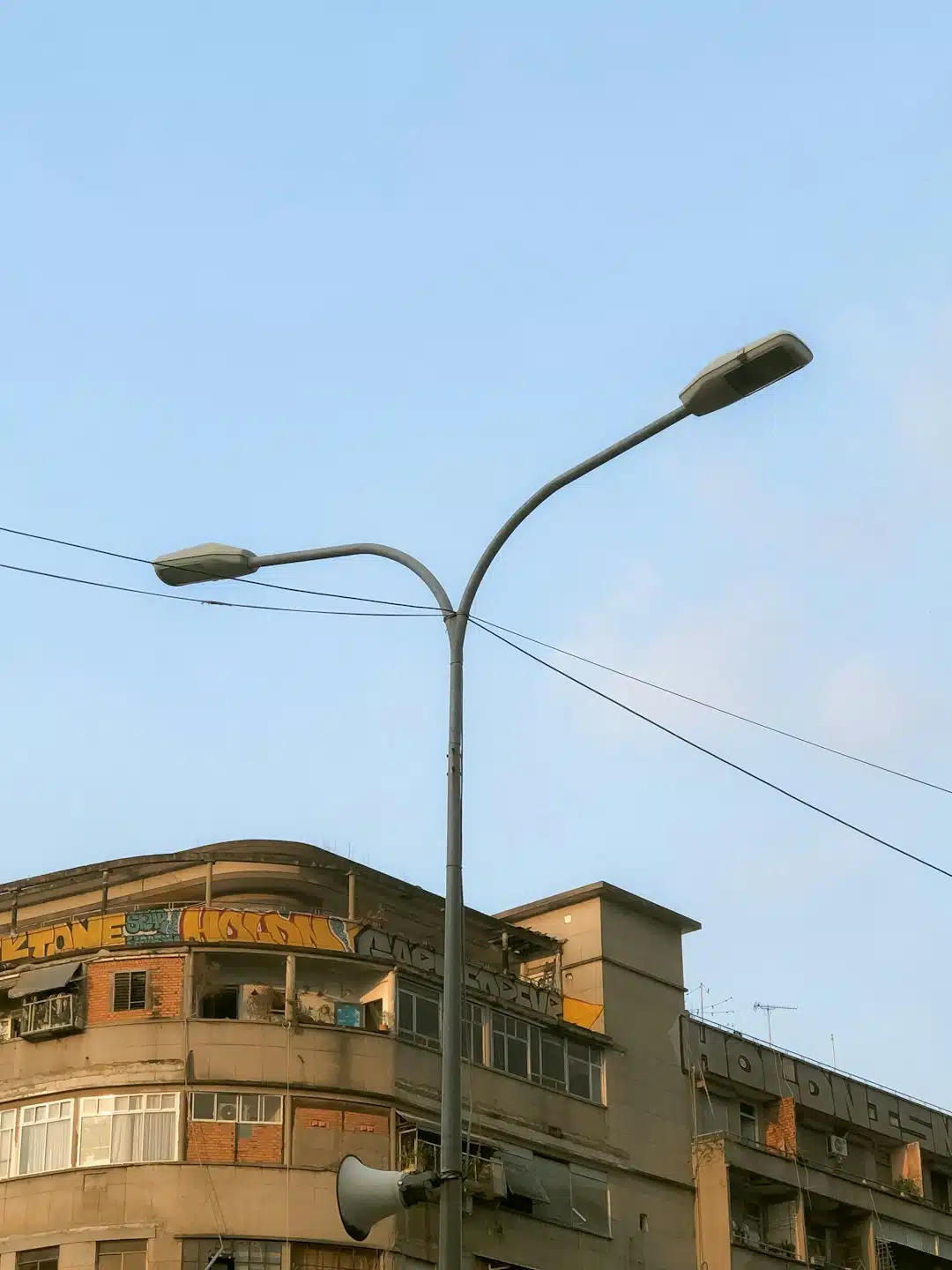 a tall building with a street light next to it