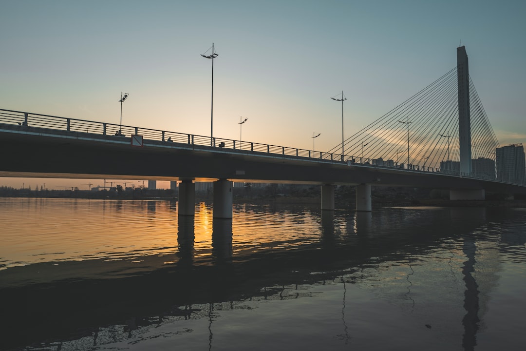 a bridge over a body of water at sunset