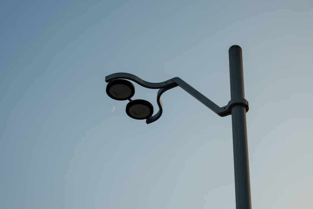 a street light with a blue sky in the background