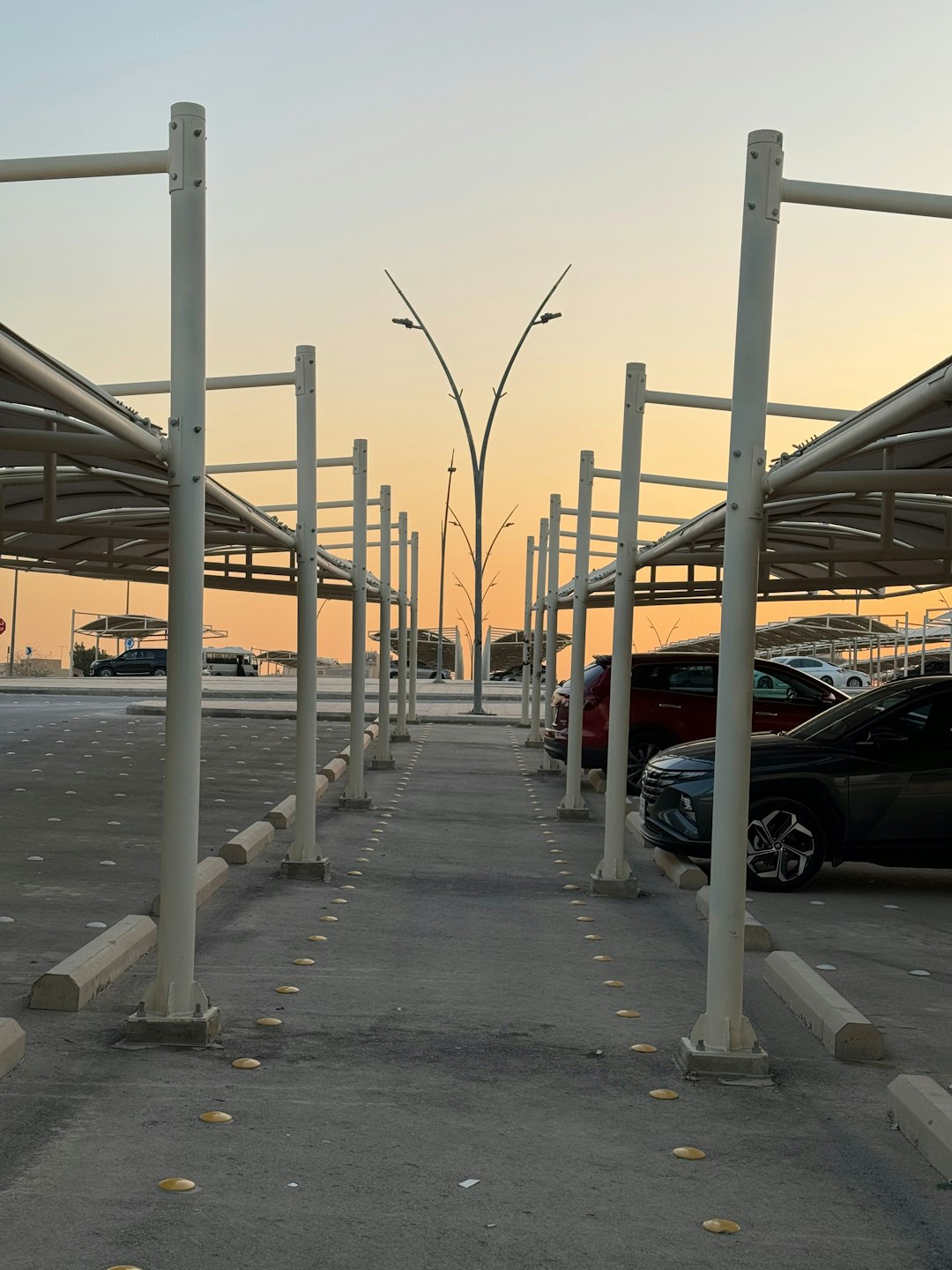 a parking lot with a row of parked cars