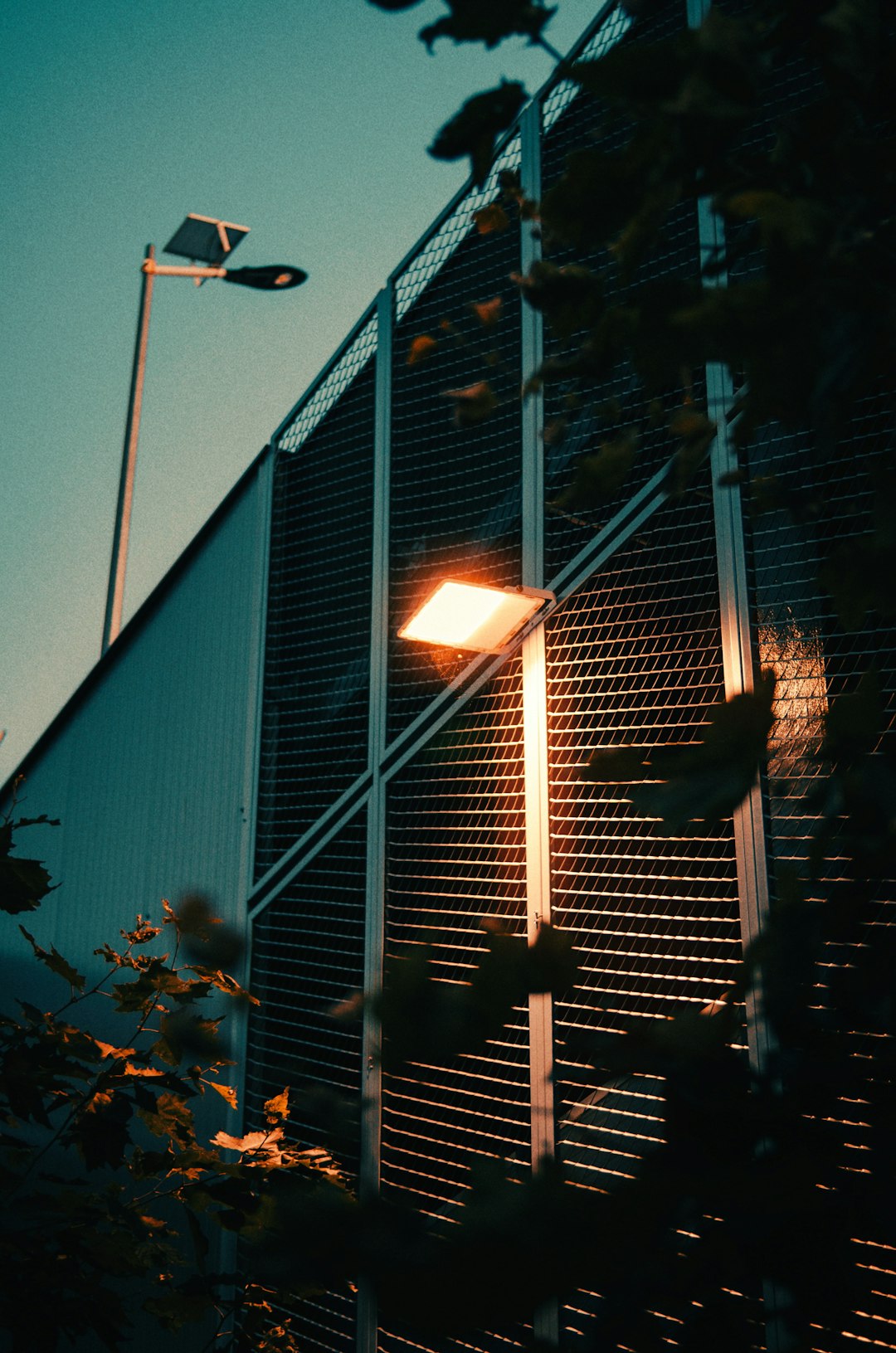A street light sitting next to a tall building