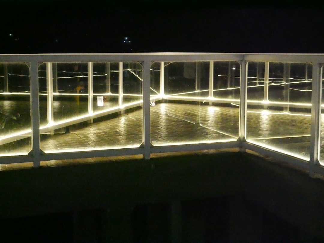 A walkway lit up with lights at night