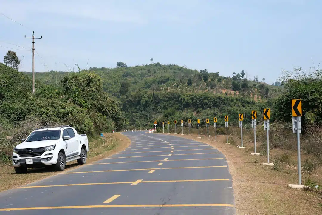A white truck parked on the side of a road