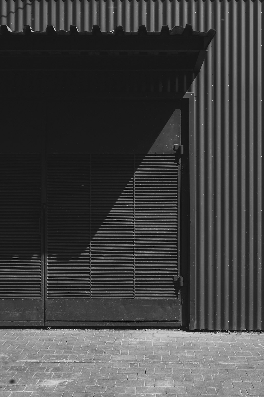 Shadows play on a building's textured exterior.